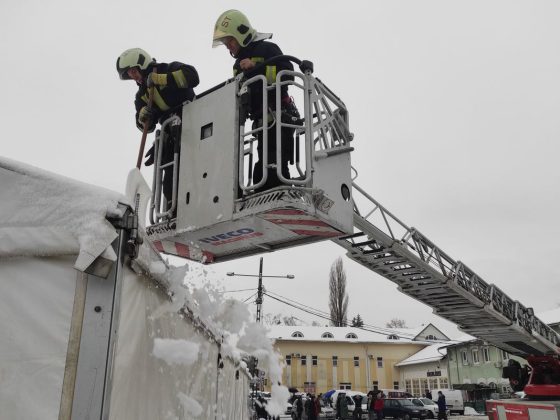 A tűzoltók takarítják le a havat a tetőről (Fotó: nool.hu)